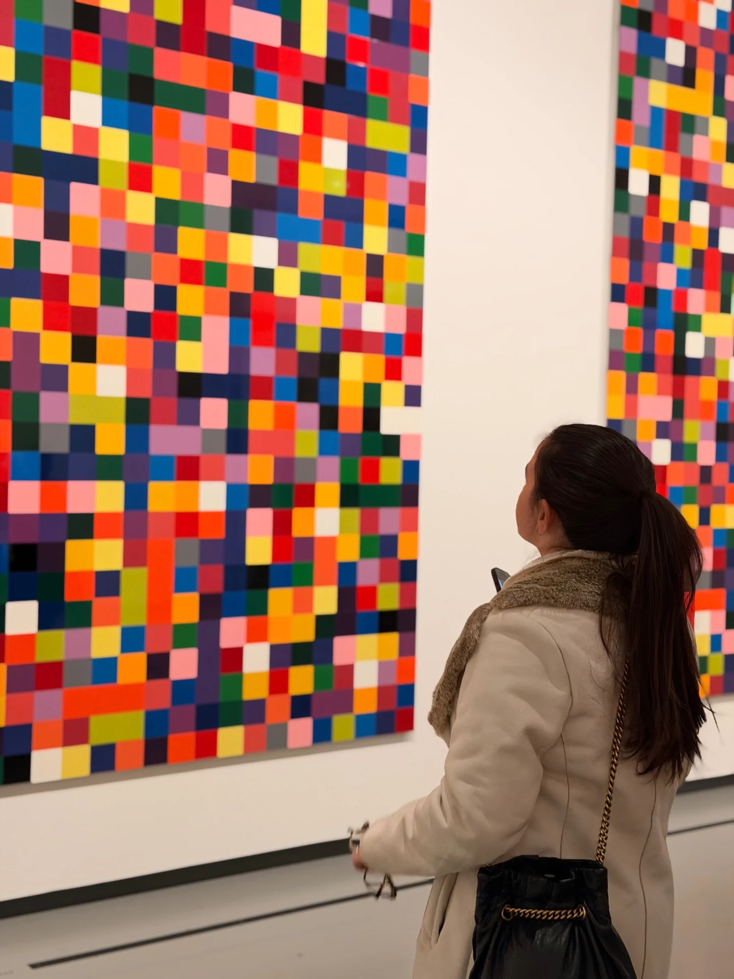 Karol viewing a Gerhard Richter color chart painting in a gallery